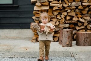 Girl Holding Wooden Logs